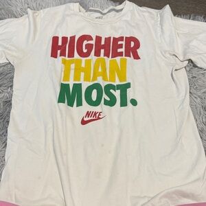 Nike White Tee with Red, Yellow, Green "HIGHER THAN MOST" Graphic